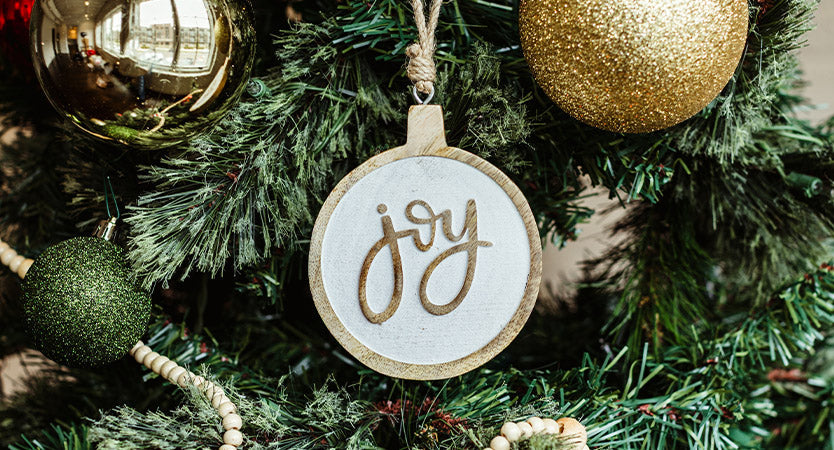 White angel wing ornament in a green Christmas tree